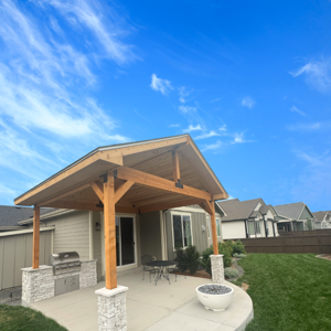 Rustic touches make this patio cover pure perfection at a recent project in Windsor, CO. A custom cedar porch cover was designed to add shade to a new concrete patio and outdoor kitchen.